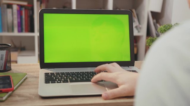 Close up laptop computer with green screen chroma key display internet business office technology work desk connection keyboard pc device using slow motion