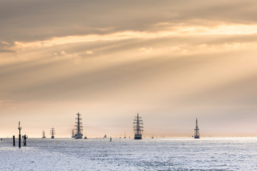 Obraz premium Tall ships leaving the Seine Estuary in the setting sun, Armada 2019, Normandy, France