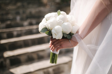 Close up of brides hands with wedding bouquet