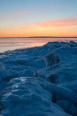 Icy sea with drift ice piling on the shore