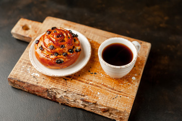 coffee and bun on stone background, morning breakfast