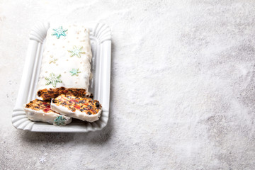 Christmas Fruit Cake, Pudding on snowy background . New Year pastries