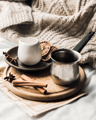 Morning coffee in Turk with cinnamon on a wooden tray in the bed. The atmosphere of comfort and romance.
