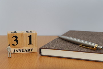 January  31, a calendar photo from the wood The table top consists of a book and pen that is ready to use. White background