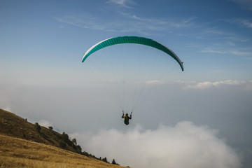 Paraglider flying over the Garda Lake,Panorama of the gorgeous Garda lake surrounded by mountains, Malcesine, Italy 