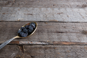 raisins photo of in metal spoon on brown table