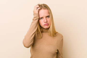 Cute and natural teenager woman tired and very sleepy keeping hand on head.