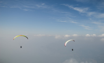 Paraglider flying over the Garda Lake,Panorama of the gorgeous Garda lake surrounded by mountains, Malcesine, Italy 