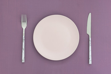 Empty black plate on dark stone background.