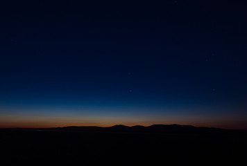 Sunset landscape view of silhouette mountains