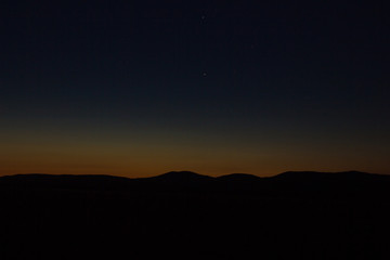 Sunset landscape view of silhouette mountains
