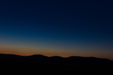 Sunset landscape view of silhouette mountains