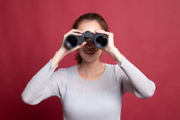 Young Asian woman with binoculars.