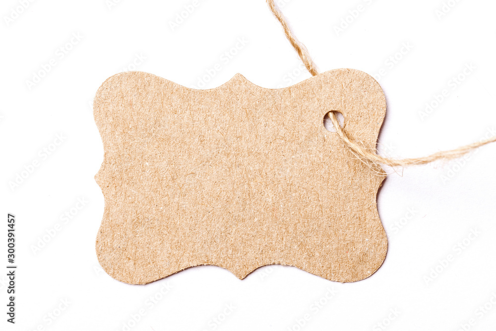 Wall mural Brown paper label tag on linen string isolated on white.