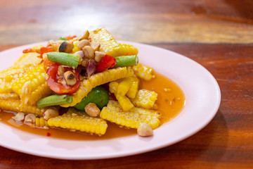 A plate of spicy and sour corn salad on wooden table