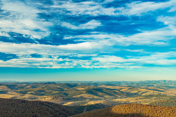top view aerial landscape photography of highland mountain hills horizon background line with vivid blue sky white clouds clear weather time 