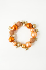 nChristmas / New Year holiday composition. Frame wreath with mock up copy space of ginger Christmas baubles, balls and stars on white background. Flat lay, top view festive concept.