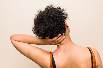 Young african american woman with skin birth mark smiling happy and confident, touching chin with...