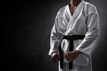 Karate martial arts fighter on dark background - obrazy, fototapety, plakaty