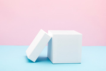 Empty, open white gift box on blue background with copy space