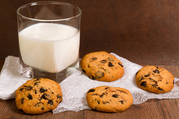 Nice dinner. Glass with milk and chocolate chip cookies.