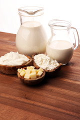 Different  healthy dairy products on rustic background with milk, cheese, butter and cottage