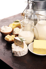 Different  healthy dairy products on rustic background with milk, cheese, butter and cottage