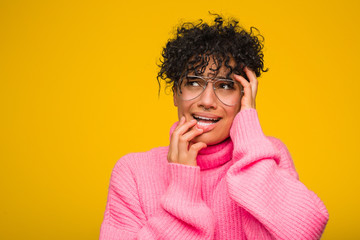 Young african american woman wearing a pink sweater whining and crying disconsolately.