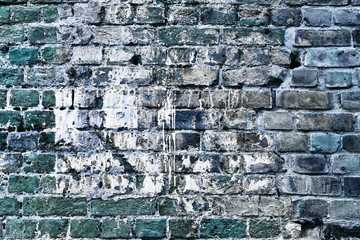 Detailed close up view on blue colored aged and weathered bricks walls in high resolution