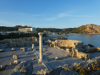 Side view of the archaeological site on the sea illuminated by the light of sunset