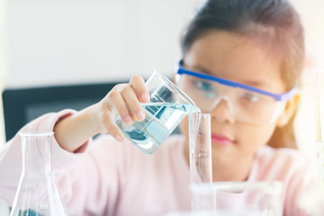 little asia kids girl in lab learning chemistry in.