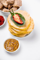 cornmeal tortillas on a white plate nearby. Mexican cuisine.