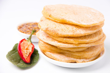 cornmeal tortillas on a white plate nearby. Mexican cuisine.