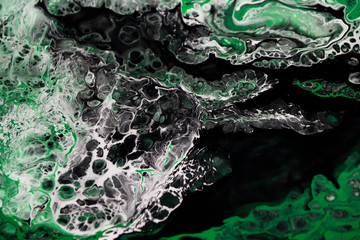 Abstract acrylic liquid pouring painting art green black and white