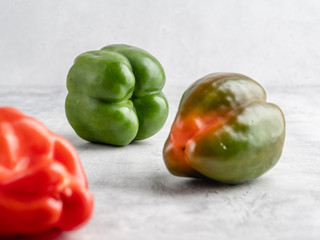 Colorful fresh peppers on white gray background