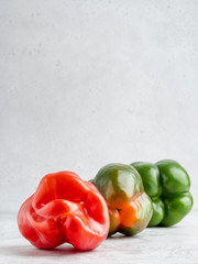 Colorful fresh peppers on white gray background