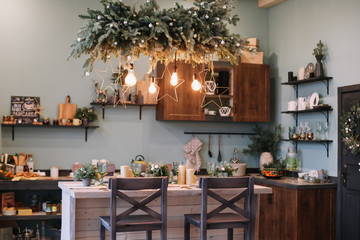 Festive kitchen in Christmas decorations. Christmas dining room. Beautiful New Year decorated...