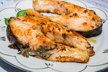 red fish in a plate, closeup. Grilled salmon.