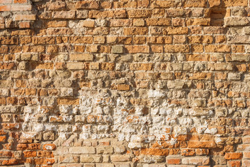 The brick texture of the castle wall. Old orange brick wall background. Close-up. Texture