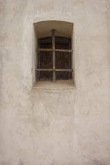 Latticed window in the wall of a Catholic church