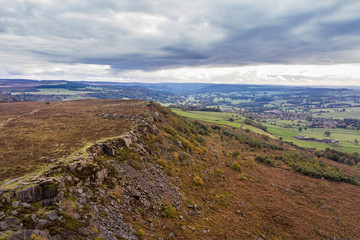 Fototapeta na wymiar Stunning Autumn Fall landscape aerial drone image of countryside view from Curbar Edge in Peak District England at sunset