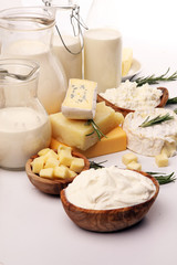 Different  healthy dairy products on rustic background with milk, cheese, butter and cottage