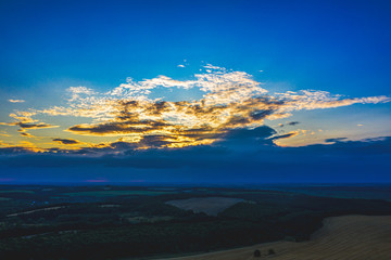 Aerial Flying over fields at harvesting time, sunset twilight time