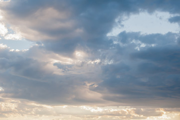 Stormy sky with dark colors brighter edges on the clouds.
