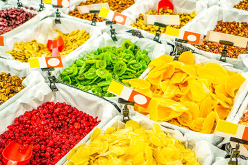 Market counter with various assorted dried fruits and nuts
