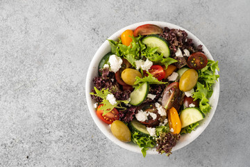 Salad of fresh vegetables and herbs with olives and feta cheese.