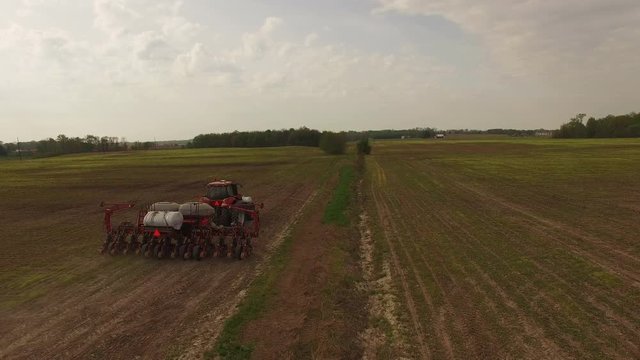 Industrial tractor in Indiana fields, wide aerial