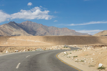 Curve asphalt road leading to big high mountain