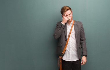 Young redhead business man embarrassed and laughing at the same time