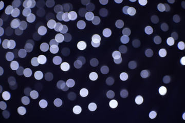 A blurred background with a group of blue circles from lighted lamps